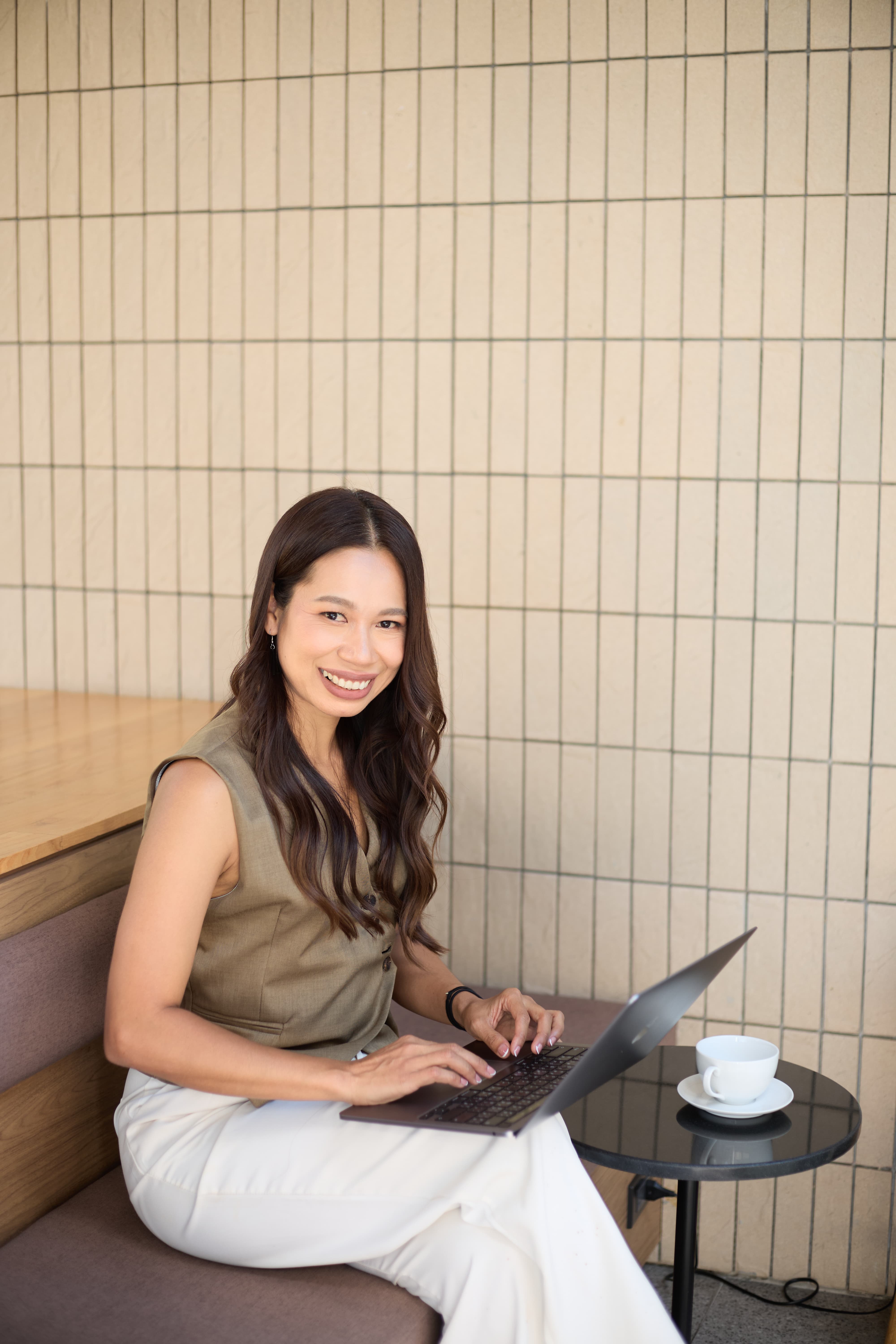 Fon Ward, SEO consultant at Search Studio, working at a cafe with laptop