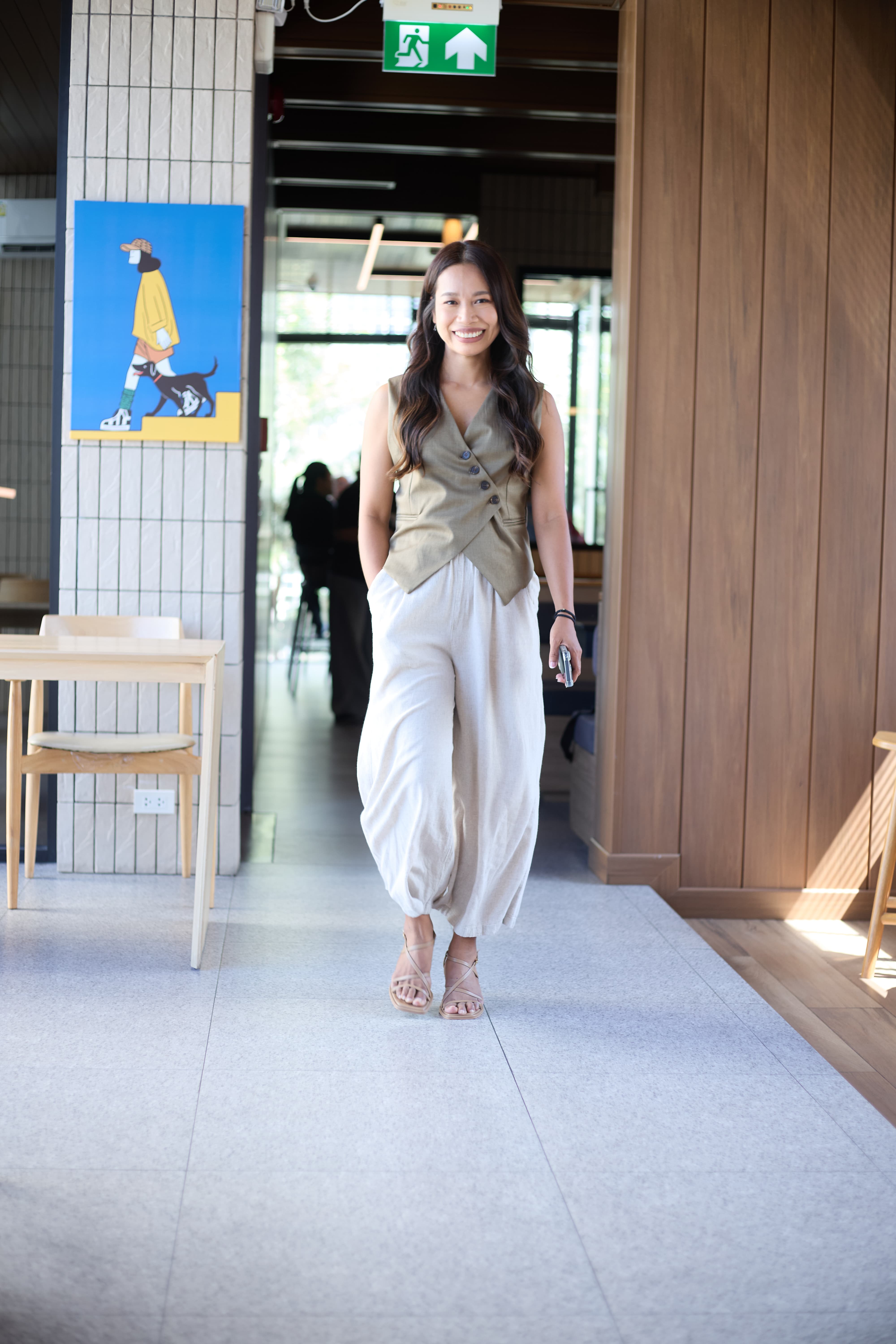 Fon Ward walking confidently through a Brisbane cafe