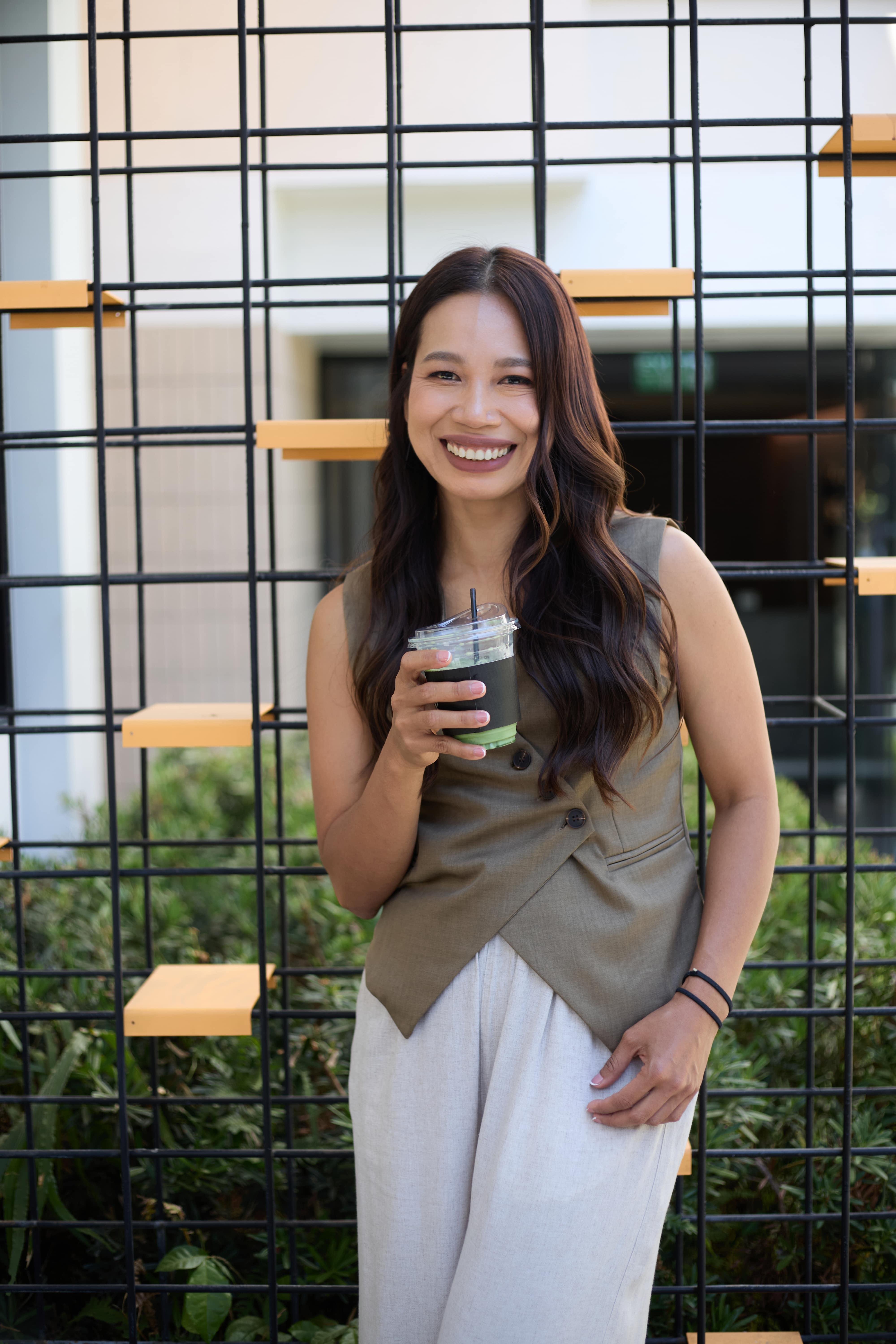 Fon Ward outdoors with iced coffee, Brisbane