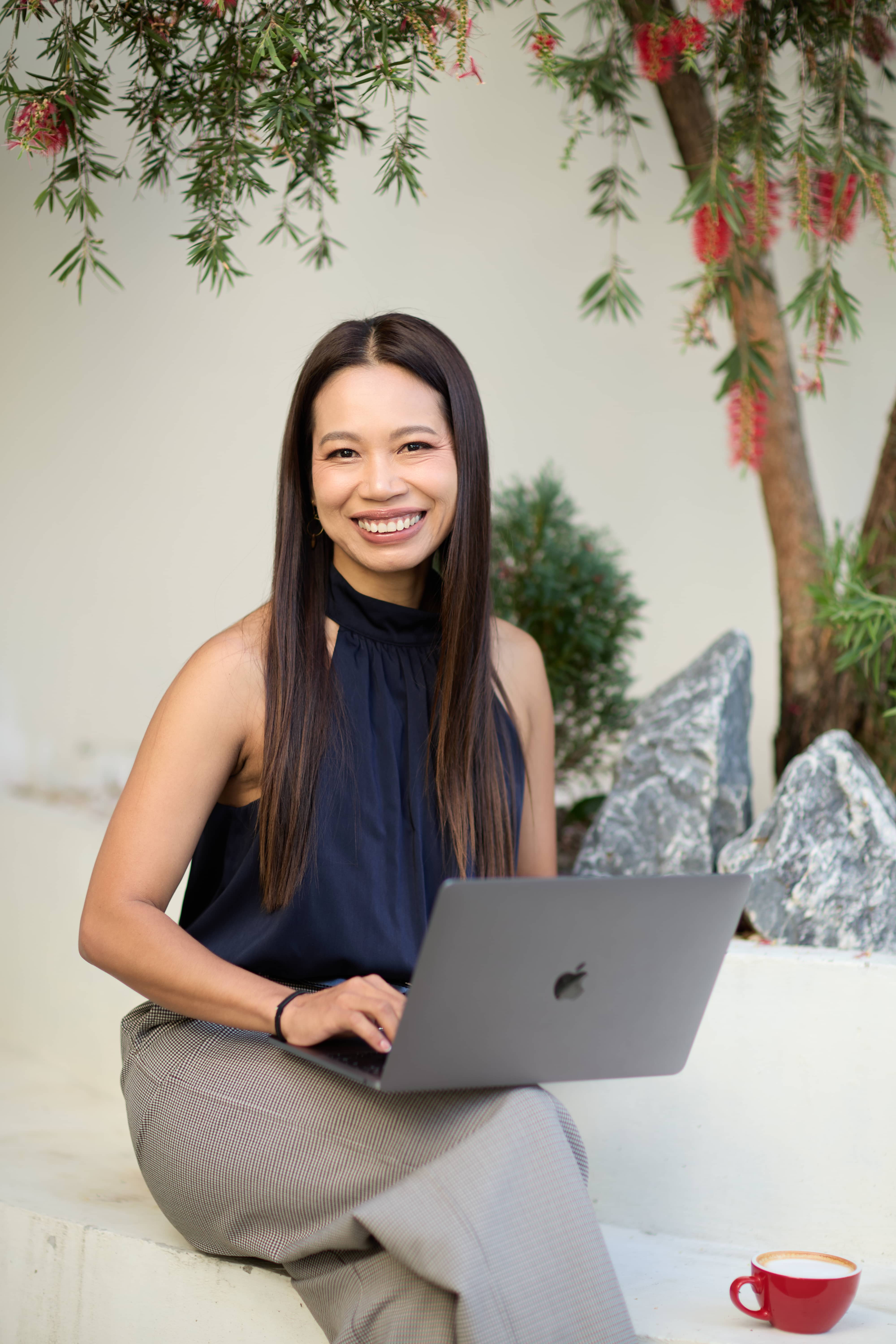 Fon Ward, on-page SEO specialist at Search Studio, working outdoors with laptop