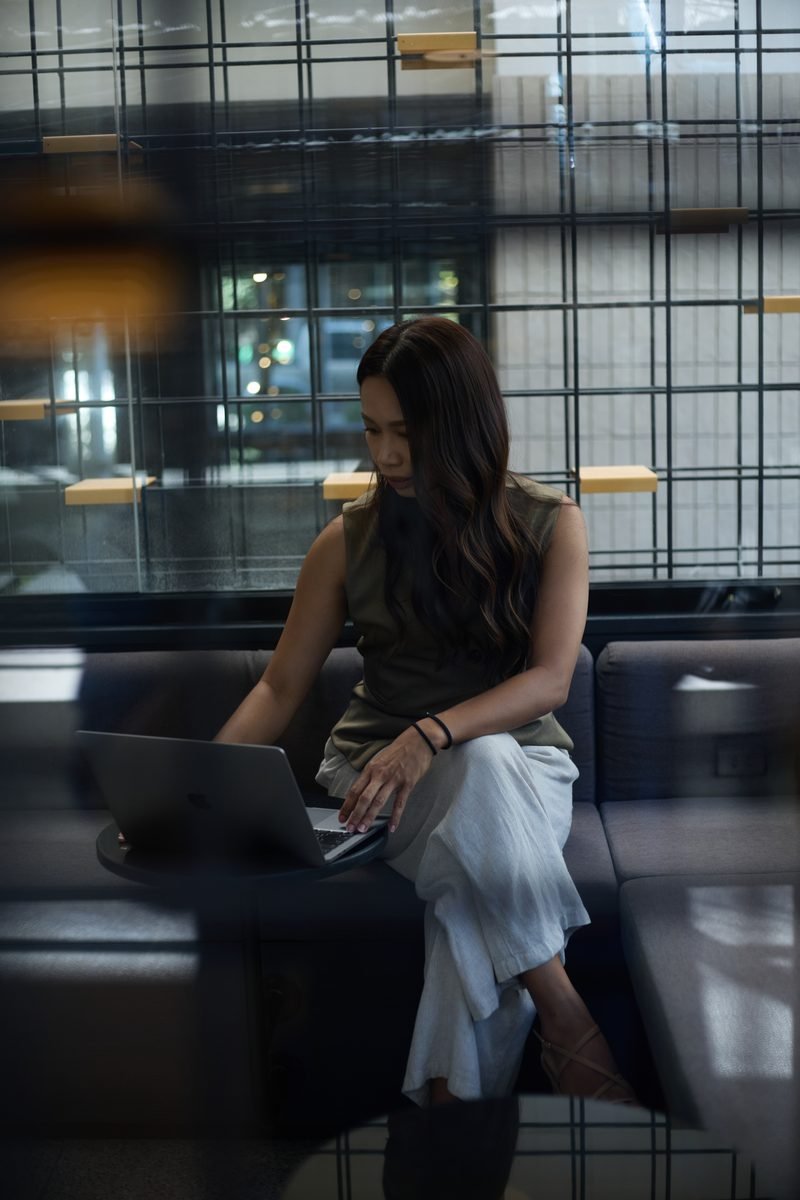 Fon Ward, SEO consultant for manufacturers at Search Studio, working on a laptop in a lounge