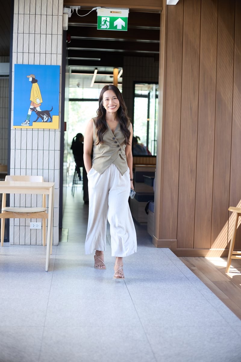 Fon Ward walking through a bright cafe, SEO consultant for aged care providers