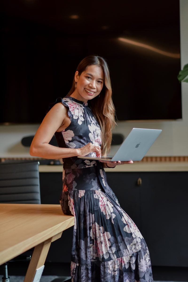Fon Ward, B2B SEO consultant at Search Studio, with her laptop in a boardroom